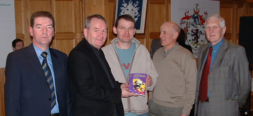 Adrian, Fr. Sean, Matt, Paddy and Fionn Gallagher with a copy of the 1992 All-Ireland Gaelic Football Final programme booklet